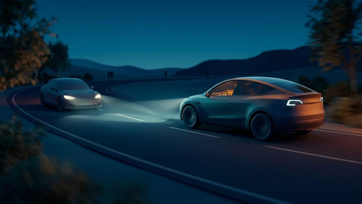 Illustration of an electric crossover at night with adaptive low beams, for Tesla software update 2026.38